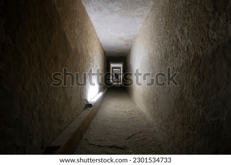 Tunnel entrance to the ancient Egyptian pyramid. A long passage in the pyramid of Giza. A prehistoric landmark. Giza, Cairo, Egypt. inside the second pyramid. Royalty-Free Stock Photo #2301534733