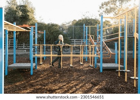 An Australian primary school girl playing on a playground in the school yard at recess Royalty-Free Stock Photo #2301546651