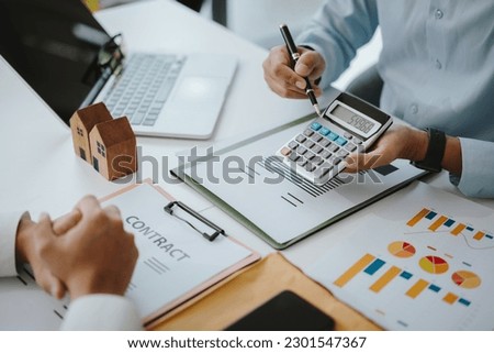 business people calculate numbers agree to make deal signing document, sale contract or legal transaction contract at desk in office,Investment in finance and accounting.