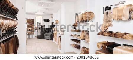 Showcase of natural looking wigs in different colors fixed on the metal wig holders in beauty salon. Row of mannequin heads with variation shades hair on shelf in wig shop
 Royalty-Free Stock Photo #2301548659