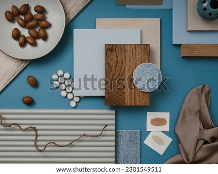 Elegant  flat lay composition in blue, brown and beige color palette with textile and paint samples, lamella panels and tiles. Architect and interior designer moodboard. Top view. Copy space. 
