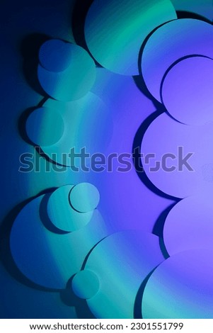 Vibrant abstract pattern of different circles fly with radial gradient of violet, aqua, turquoise, deep blue color, shadows. Abstract background in fashion or disco party style, vertical.