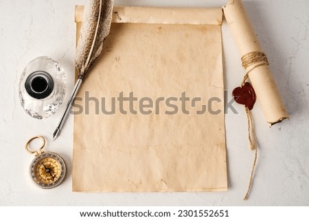 Old paper with compass and quill pen top view
