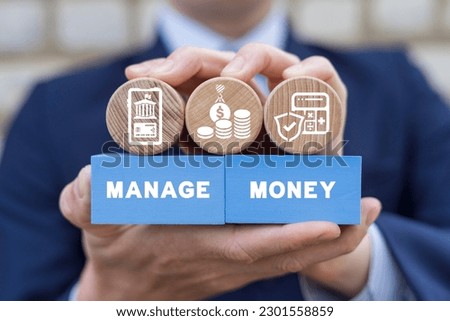Businessman holding colorful blocks with icons and inscription: MANAGE MONEY. Concept of money management, financial investment, market movement. Manage money through your mobile phone, applications.