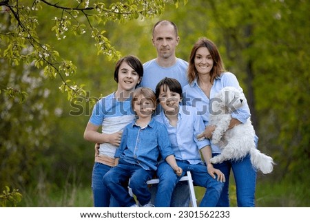 Beautiful family in the park, taking family portrait pictures together
