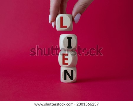 Lien symbol. Concept word Lien on wooden cubes. Businessman hand. Beautiful red background. Business and Lien concept. Copy space.