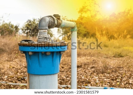 Groundwater wells are drilled and water is supplied with PVC pipes, groundwater pumping systems are powered by electricity to solve drought problems. Royalty-Free Stock Photo #2301581579