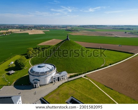 Aerial view farm field, Lion's Mound, Battle field, Napoleon, Waterloo, Belgium, green and sky, season. Aerial View at the Waterloo Hill with the statue of the lion of Memorial Battle of Waterloo Royalty-Free Stock Photo #2301582095