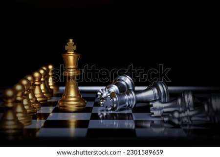 The golden chess king leads the silver chess pieces on the chessboard, business, success, competition,Teamwork and leadership concept. Royalty-Free Stock Photo #2301589659