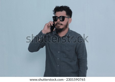asian man expression using smartphone white background