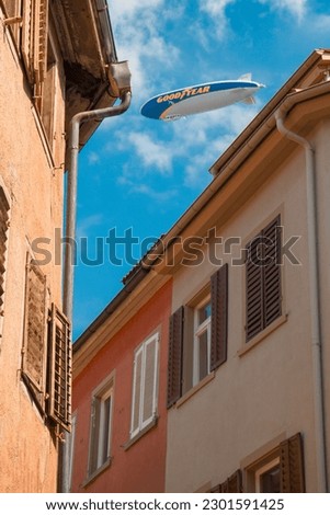 walls of old houses, sky and airship Royalty-Free Stock Photo #2301591425