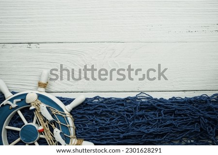 Nautical ornaments Antique sail boat Toy model and lifebuoy on wooden background