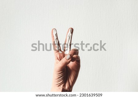 Correct application of sunscreen on 2 fingers spf 50. Royalty-Free Stock Photo #2301639509