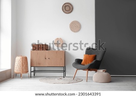 Interior of stylish living room with wooden cabinet and cozy armchair Royalty-Free Stock Photo #2301643391