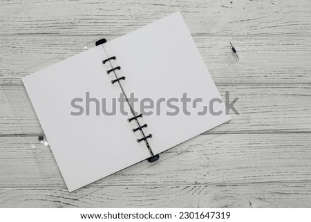Notebook with rings, checkered sheets, transparent cover, study concept.