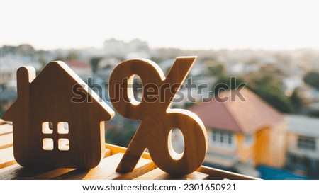 Silhouette of Percentage and house sign symbol icon wooden on wood table. Concepts of home interest, real estate, investing in inflation.