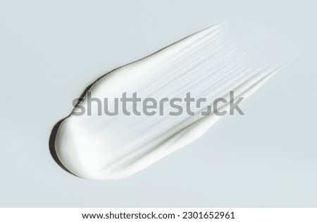 cosmetic smears of creamy texture on gray background Royalty-Free Stock Photo #2301652961