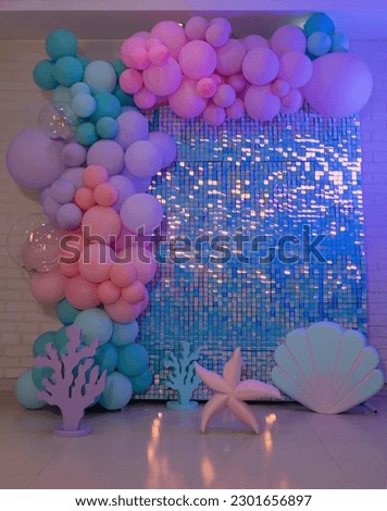 mermaid balloons background of studio photography. pink and purple and green balloons with blue background birthday theme.