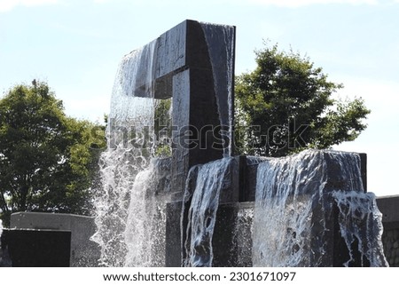 Abstract photo of a water fountain as water is frozen in time. A beautiful photo on a sunny day. High shutter speed. 