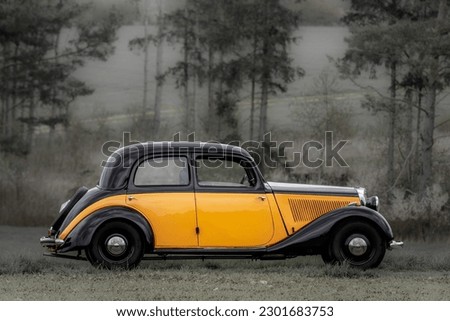 Retro style photo of a classic oldtimer vintage car of the 1930s - 1940s in a forest Royalty-Free Stock Photo #2301683753