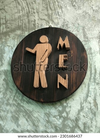 Photo of the men's restroom sign.
