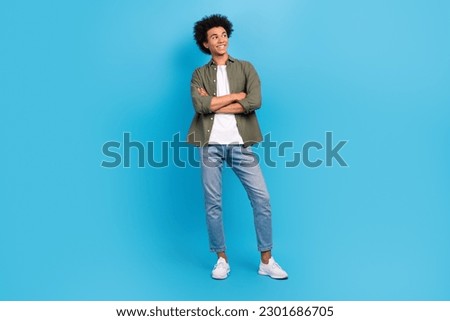 Full body photo of young model handsome guy crossed hands confident wear khaki shirt jeans look mockup isolated on blue color background