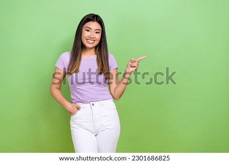 Photo portrait of pretty japanese korean young girl finger point empty space wear trendy purple outfit isolated on green color background