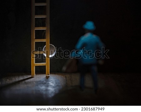 Man behind the wall with ladder in the spot light