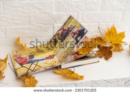 dry autumn leaves and a photo album