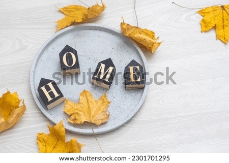 Yellow leaves on a light background with the inscription home.