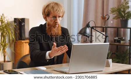 Irritated shocked business man while working on laptop, unexpected online website problem, computer virus data loss by hacking. Manager freelancer feeling mad about broken notebook at office workplace