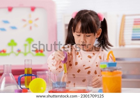 young girl doing science experiment at home