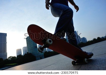 woman skateboarder skateboarding at sunrise city
