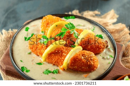 closeup Cordon Bleu meal, crispy rolled chicken breast stuffed with cheese and ham melted in cream Royalty-Free Stock Photo #2301736211