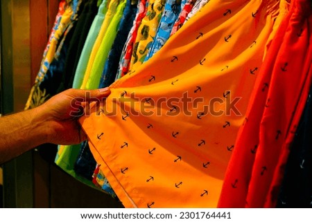 woman and man looking at clothes and shopping in mall