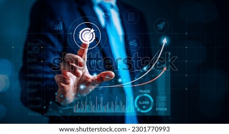 Businessman engaged in deep analysis technology and strategic planning, surrounded by charts, diagrams, and graphs that illustrate his stock analysis, investment portfolio, and profit targets Royalty-Free Stock Photo #2301770993