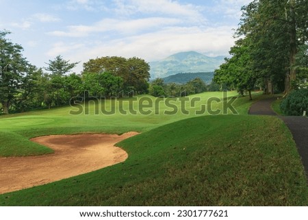 Panorama View of Golf Course with putting green in Taman Dayu Pandaan, Pasuruan, East Java, Indonesia. Golf course with a rich green turf beautiful scenery.