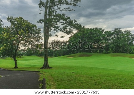 Panorama View of Golf Course with putting green in Taman Dayu Pandaan, Pasuruan, East Java, Indonesia. Golf course with a rich green turf beautiful scenery.