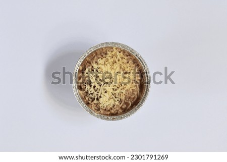 chocolate brownie cake sprinkled with cheese on a white background