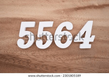 White number 5564 on a brown and light brown wooden background.