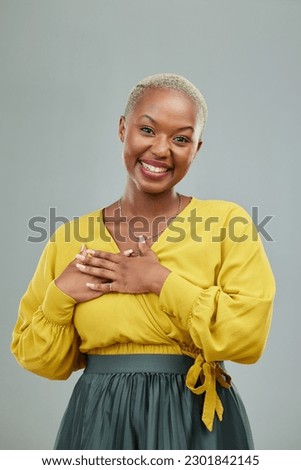 Portrait, thank you and hands on chest of happy woman in studio with love sign on wall background. Face, smile and hand on heart by female person showing gratitude, kindness and self care or honesty Royalty-Free Stock Photo #2301842145