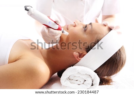 Needle mesotherapy.Beautician performs a needle mesotherapy treatment on a woman's face Royalty-Free Stock Photo #230184487
