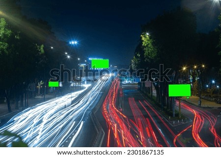Time lapse photo at Nguyen Thai Son overpass, Ho Chi Minh city with billboards with green background in Vietnam