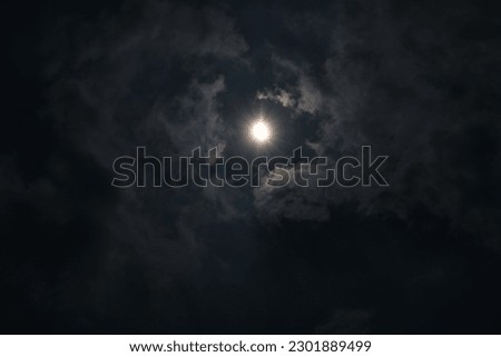 Hybrid Solar Eclipse.
The night sky is filled with dark clouds, illuminated by the bright full moon and its magical moonlight. Royalty-Free Stock Photo #2301889499