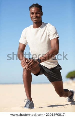 young man doing exercise on the beach