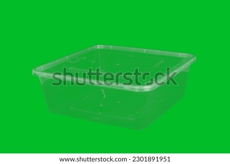 a medium-sized blank plastic thinwall for storage with a green background, can be used for green screen design assets