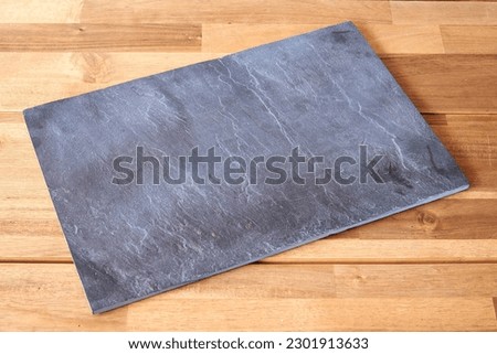 Textured wooden bench and shist plate  in close-up for background