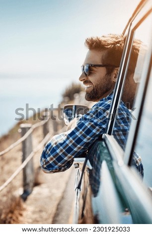 Road trip, travel and man in window of car driving for adventure, summer vacation and holiday. Transportation, relax and face of male person in motor vehicle for freedom, journey and happy by ocean Royalty-Free Stock Photo #2301925033