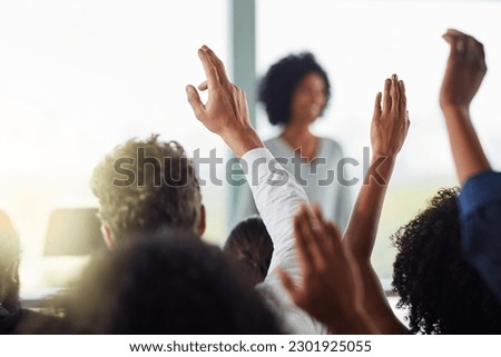 Back, business people and hands raised for questions at conference, seminar or meeting. Group, audience and hand up for question, asking or answer, crowd vote and training at workshop presentation. Royalty-Free Stock Photo #2301925055