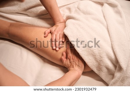 Wellness center masseuse giving massage to client